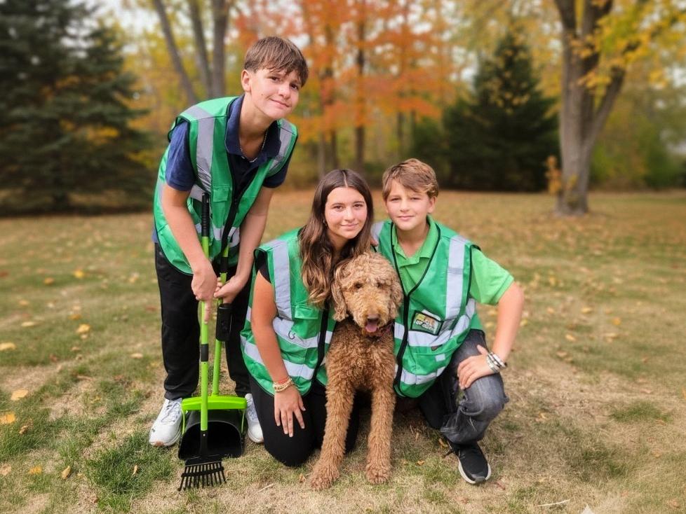 Poop Scooping Service Car with Employees Standing In Front
